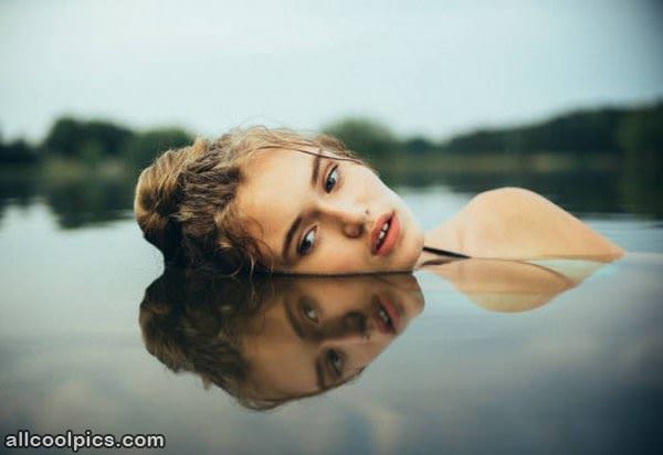 face reflection in water